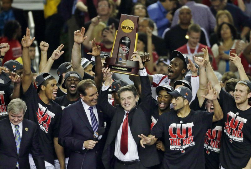 FILE - In this April 8, 2013, file photo, Louisville players and head coach Rick Pitino celebrate after defeating Michigan 82-76 in the championship of the Final Four in the NCAA college basketball tournament in Atlanta. 