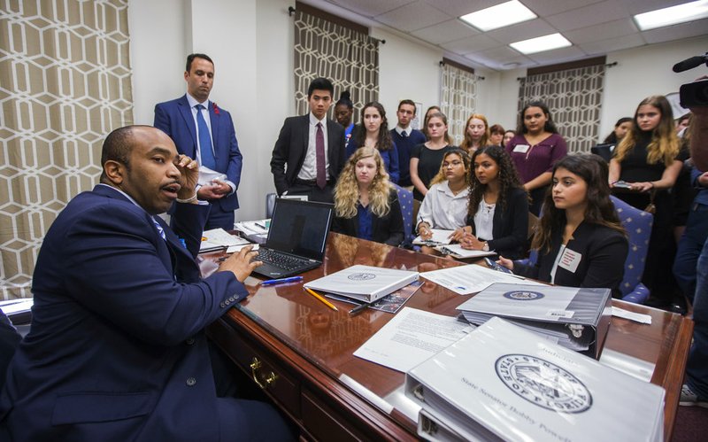 Sen. Bobby Powell talks with survivors from Marjory Stoneman Douglas High School and other students from Broward County, Fla., high schools in his office at the Florida Capital in Tallahassee, Fla., on Feb 20, 2018.