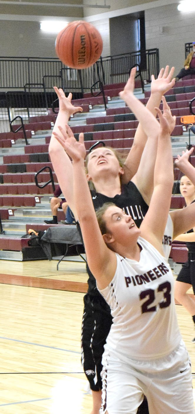 Westside Eagle Observer/MIKE ECKELS Hailey Hayes (Pioneer 23) and Kara Drewyer (Hunstville 33) fight for a rebound during the first round of the 4A District tournament contest between the Lady Pioneers and Lady Eagles at Lincoln High School Feb. 13.