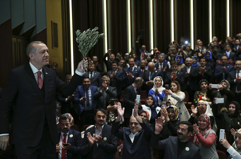 The Associated Press OPERATION OLIVE BRANCH: Turkey's President Recep Tayyip Erdogan, holding an olive branch arrives to deliver a speech at an event Tuesday in Ankara, Turkey. Erdogan said Turkish troops involved in the month-long offensive, codenamed 'Operation Olive Branch', to drive out Syrian Kurdish militiamen from a northwestern Syrian enclave will soon begin a siege of the city of Afrin.