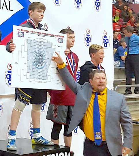 Submitted photo REIGNING RAM: Lakeside wrestling coach H.E. Burchard, right, congratulates Chance Mahan on winning the 113-pound state title in the 2018 Centennial Bank State High School Wrestling Championship at the Jack Stephens Center on the University of Arkansas at Little Rock. Mahan is the first Lakeside wrestler to win a state championship.