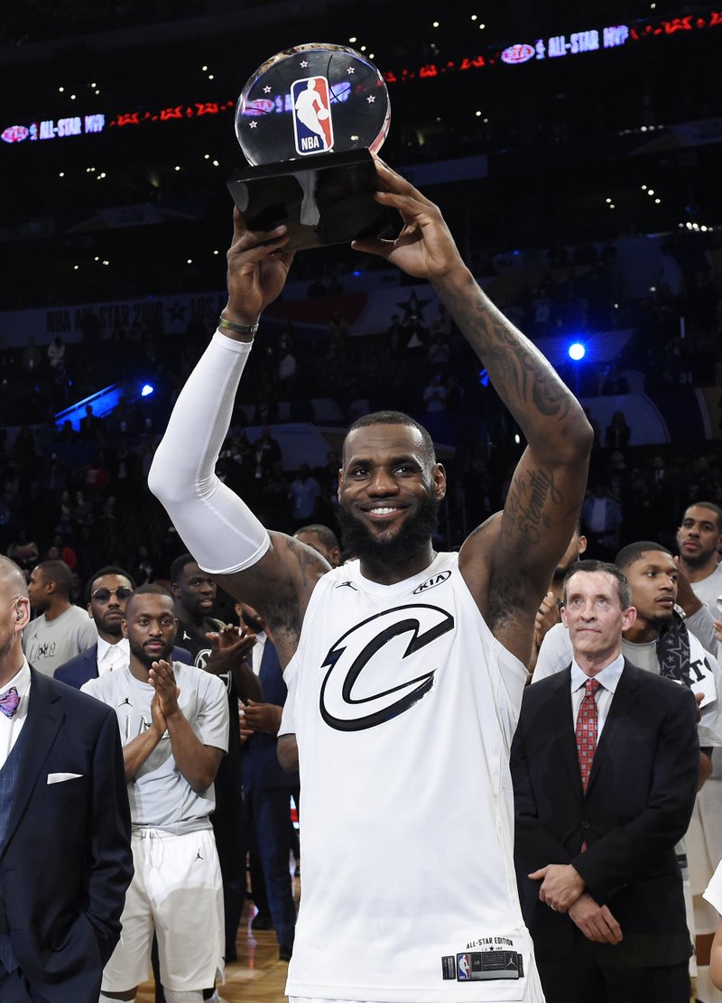 Team LeBron's LeBron James, of the Cleveland Cavaliers, holds MVP trophy after his team defeated Team Stephen at the NBA All-Star basketball game, Sunday, Feb. 18, 2018, in Los Angeles. Team LeBron won 148-145. (AP Photo/Chris Pizzello)