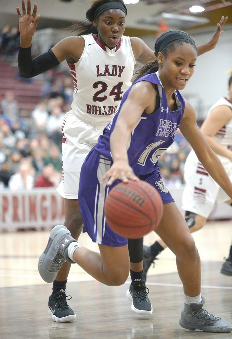 Fayetteville’s Coriah Beck (right) tries to control a loose ball in front of Marquesha Davis of Springdale High on Tuesday at Bulldog Gymnasium in Springdale. Visit nwadg.com/photos for more photos from the games.