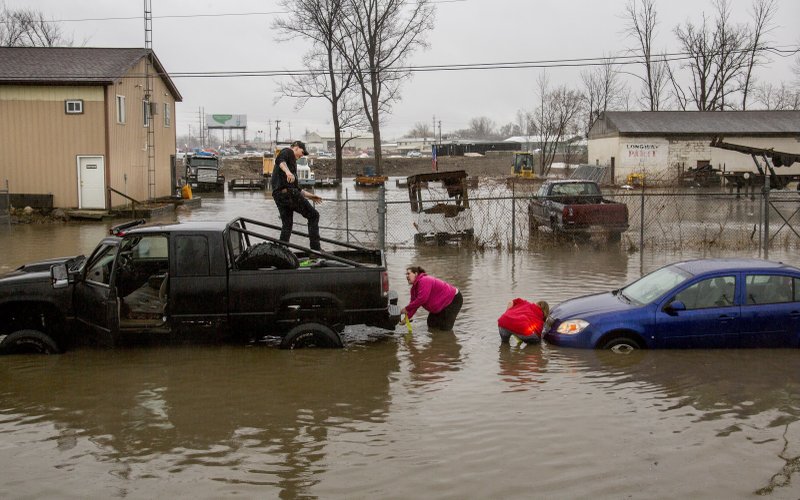 High floor waters caused several motorists to become stuck on Tuesday, Feb. 20, 2018, in Flint, Mich. High water from storm flooding closed roads in Michigan. 