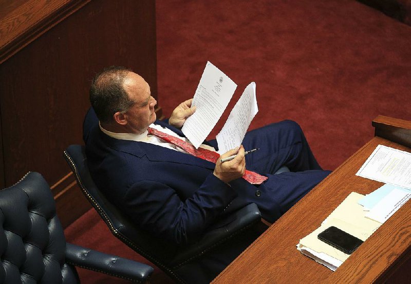 FILE - Sen. Jimmy Hickey, R-Texarkana, looks over appropriation bills that senators voted on at the state Capitol during the Legislature’s fiscal session in 2018.