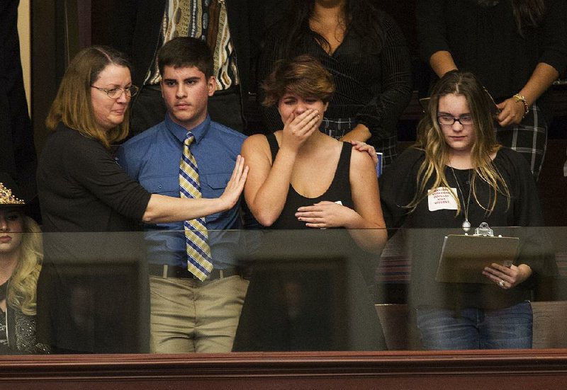 Sheryl Acquarola (right), a 16-year-old junior at Marjory Stoneman Douglas High School in Parkland, Fla., watches Tuesday from the gallery as a motion to consider a ban on assault rifles and high-capacity gun magazines is voted down in the Florida House of Representatives in Tallahassee.   
