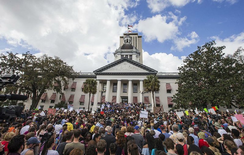 Young protesters rally Wednesday outside the Florida Capitol in Tallahassee to call for tougher laws on assault rifles. Lawmakers said they would reconsider allowing 18-year-olds to buy such weapons. 