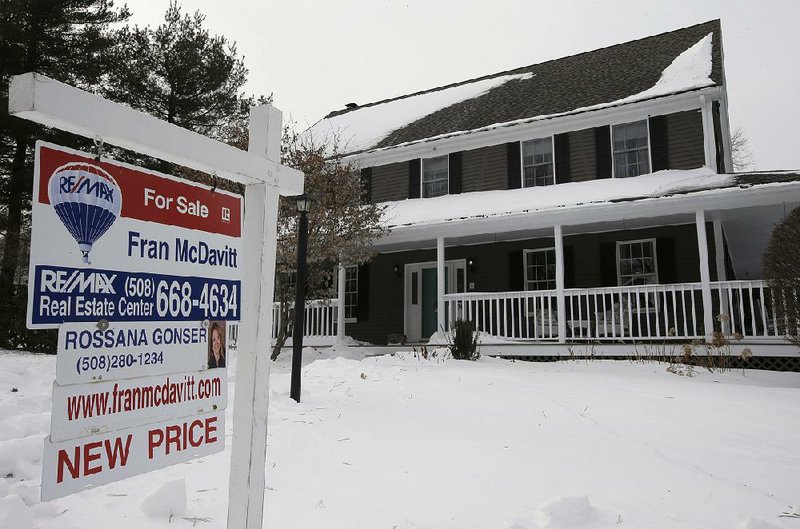 A for-sale sign hangs in front of a home in Walpole, Mass. The total supply of homes for sale dipped in January to 1.52 million, the fewest for any January since records began in 1999. 