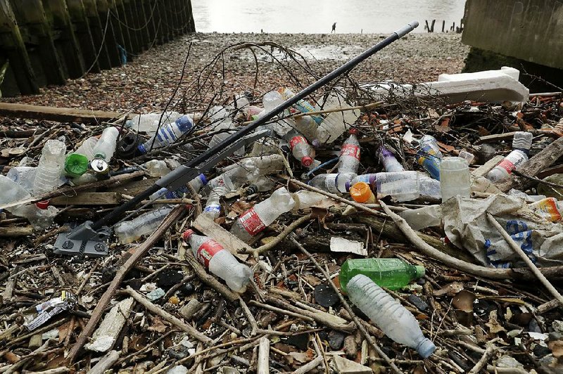 Bottles and other plastics, including a mop, litter the site of the ancient and no-longer used Queenhithe dock on the River Thames in London recently. 
