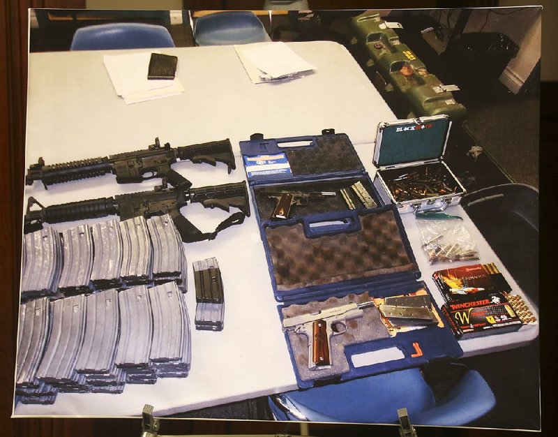 A cache of weapons, ammunition and high-capacity magazines seized at a Southern California student’s home are displayed at a news conference Wednesday in Los Angeles. 
