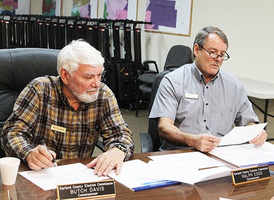 The Sentinel-Record/Richard Rasmussen GETTING READY: Garland County election commissioners Harold "Butch" Davis, left, and Ralph Edds make preparations for the May 22 elections. They were appointed to the commission by their respective county party committees in January 2017.