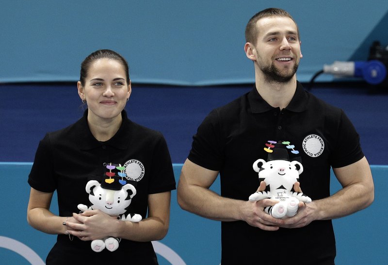 The Associated Press GIVE IT BACK: Russian athletes Anastasia Bryzgalova, left, and Alexander Krushelnitsky smile as they win a bronze medal during the venue ceremony for the mixed doubles curling match at the 2018 Winter Olympics in Gangneung, South Korea, on Feb. 13. Krushelnitsky tested positive for a banned substance at the Pyeongchang Olympics, and he admitted the infraction, adding that he will return the medal.