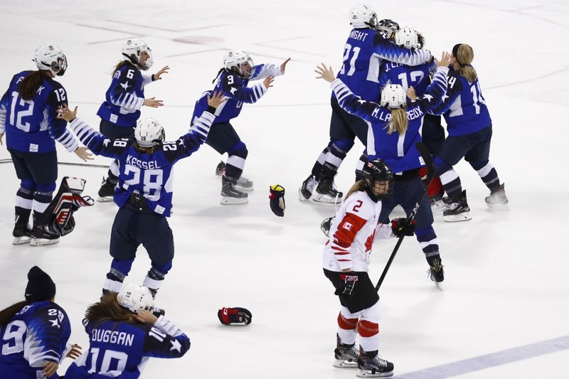 Canada's Meghan Agosta(2) skates away as the United States players celebrate after winning the women's gold medal hockey game against Canada at the 2018 Winter Olympics in Gangneung, South Korea, Thursday, Feb. 22, 2018. 