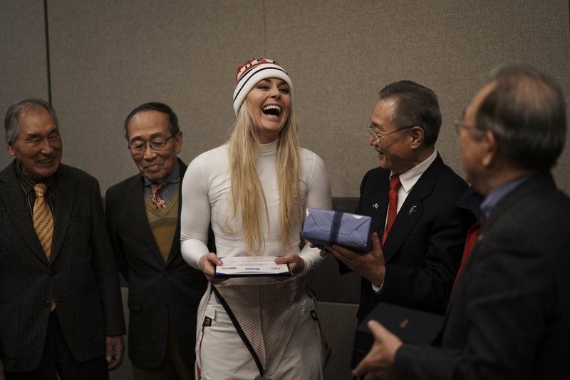 United States' Lindsey Vonn, center, smiles as she receives gifts and a letter of appreciation for her grandfather's service during the Korean War from members of the Yongsan Club in Jeongseon, South Korea, Thursday, Feb. 22, 2018. 