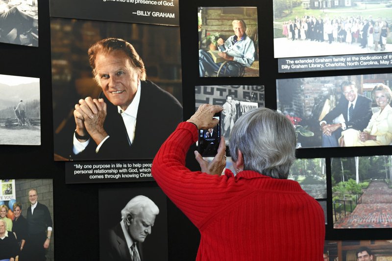 Lyn Warwick of Black Mountain, N.C., photographs a memorial display of Rev. Billy Graham inside Chatlos Chapel at the Billy Graham Training Center at the Cove on Wednesday, February 21, 2018 in Asheville, NC. Warwick is friends with Gigi Graham, Billy Graham's daughter. 