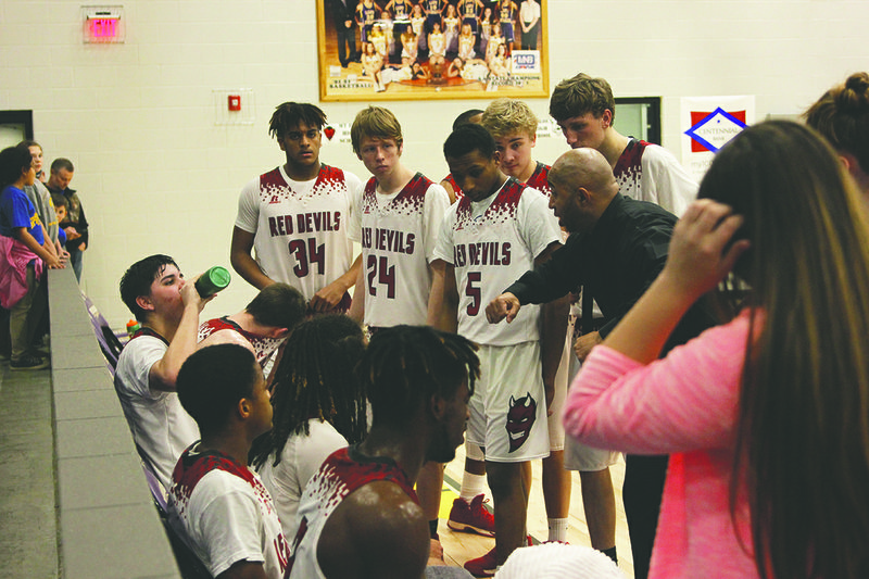 The Sentinel-Record/James Leigh REGIONAL CHALLENGE: Mountain Pine head coach LaMont Page speaks to him Thursday during the Red Devils’ 77-73 loss to Beard in the semifinals of the 2A-South regional tournament in Poyen. The Red Devils will return to Poyen today for a 1:30 p.m. matchup with Parkers Chapel or Camden Harmony Grove in the third-place game.