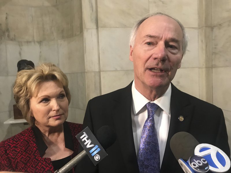 Arkansas Gov. Asa Hutchinson speaks to reporters at the state Capitol on Thursday in Little Rock after filing paperwork to run for re-election. Hutchinson made his bid for a second term official Thursday as he joined dozens of other candidates for state and federal office at the start of filing for this year's election. (AP Photo/Andrew Demillo)