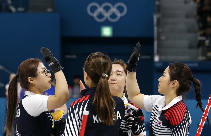 In this Feb. 21, 2018 photo, South Korea's women's curling team celebrate after beating Russian athletes during their match at the 2018 Winter Olympics in Gangneung, South Korea. The team known as the "Garlic Girls" came into the Pyeongchang Games as the underdog who few believed would medal. Now they're No. 1 in the rankings.