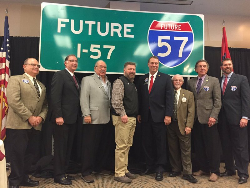 Officials pose with sign designating home of "Future Interstate 57" on Friday, Feb. 23, 2018.