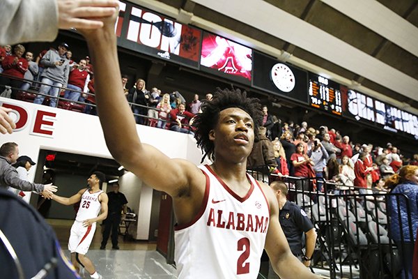 Alabama guard Collin Sexton (2) celebrates by giving high fives to fans after an NCAA college basketball game, Saturday, Dec. 30, 2017, in Tuscaloosa, Ala. (AP Photo/Brynn Anderson)
