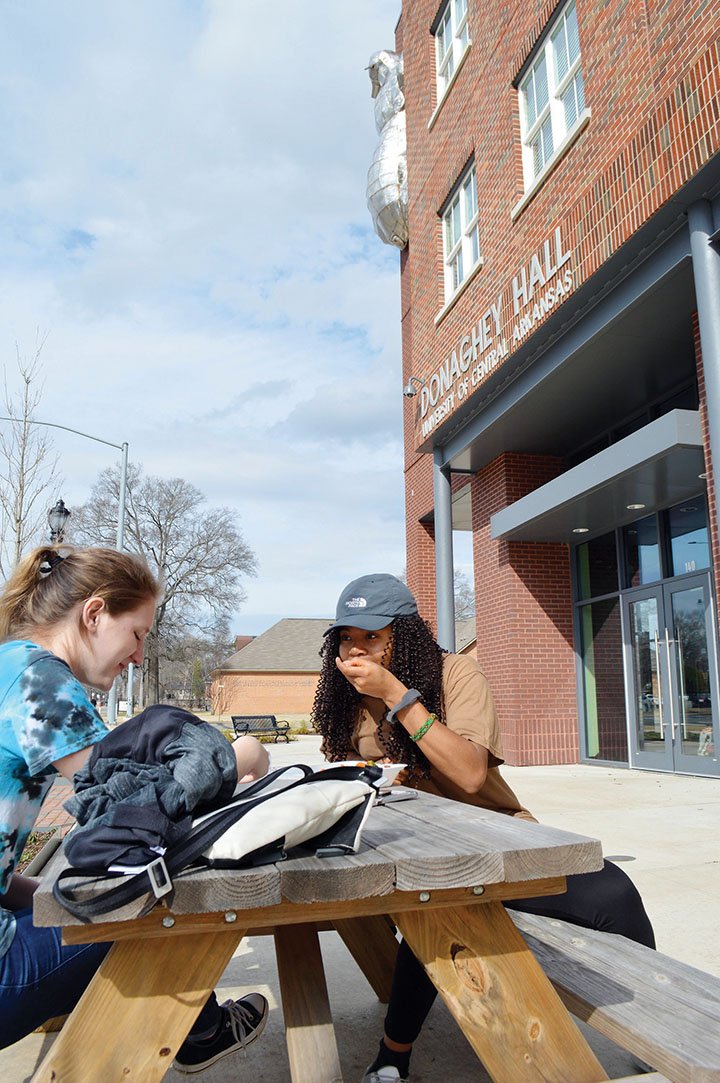 University of Central Arkansas students Samantha Pierce of Batesville, left, and Nena Igbokidi of Hot Springs sit at a table in front of UCA’s Donaghey Hall. They are eating ice cream from Marble Slab Creamery. Four retail businesses at the location have closed since December, but UCA officials said the bottom spaces will be repurposed soon. Marble Slab will remain open.
