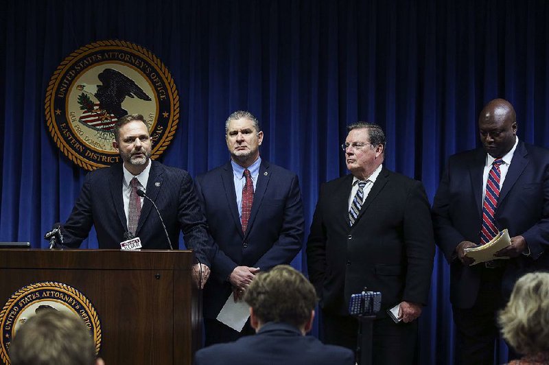 “Today’s operation is a victory over gun, gang and drug violence,” Cody Hiland (left), U.S. attorney for the Eastern District of Arkansas, said Thursday. With Hiland are Stephen Azzam (second from left), Little Rock special agent in charge of the federal Drug Enforcement Administration, Little Rock Mayor Mark Stodola and Little Rock Police Chief Kenton Buckner.