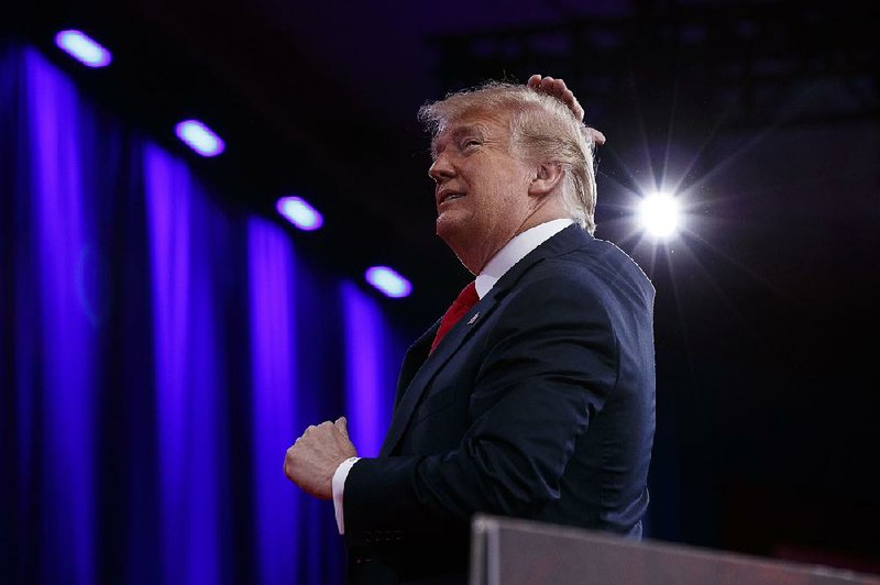 President Donald Trump makes a joke about his hair Friday during remarks to the Conservative Political Action Conference that touched on gun laws and his 2016 campaign themes.