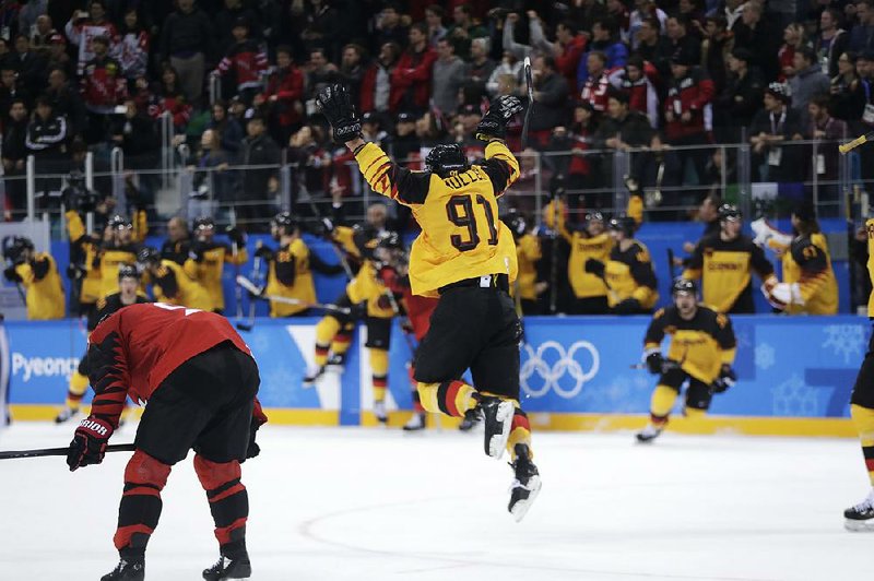 Defenseman Moritz Mueller (91) celebrates while his teammates storm the ice Friday after Germany defeated Canada 4-3 in the men’s hockey semifinals. Germany takes on the Olympic Athletes of Russia today for the gold medal, while Canada faces the Czech Republic for the bronze medal.  