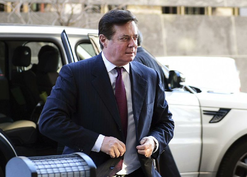 Former Trump campaign chairman Paul Manafort arrives for a federal court appearance Dec. 11 in Washington. Manafort and longtime associate Rick Gates, already facing fraud and money-laundering charges, were accused Thursday of lying on their income-tax returns and conspiring to commit bank fraud to get loans.  