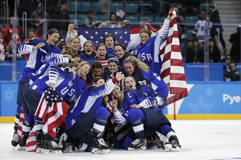 The United States women’s hockey team celebrates with their gold medals on Thursday after defeating Canada in Gangneung, South Korea.