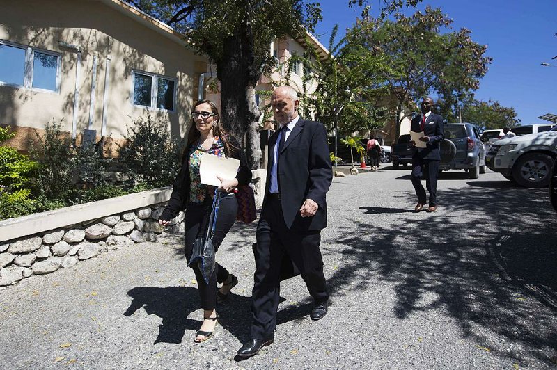 Oxfam International executives Margalida Massot and Simon Ticehurst leave a Thursday meeting with a Haitian government official in Port-au-Prince.  