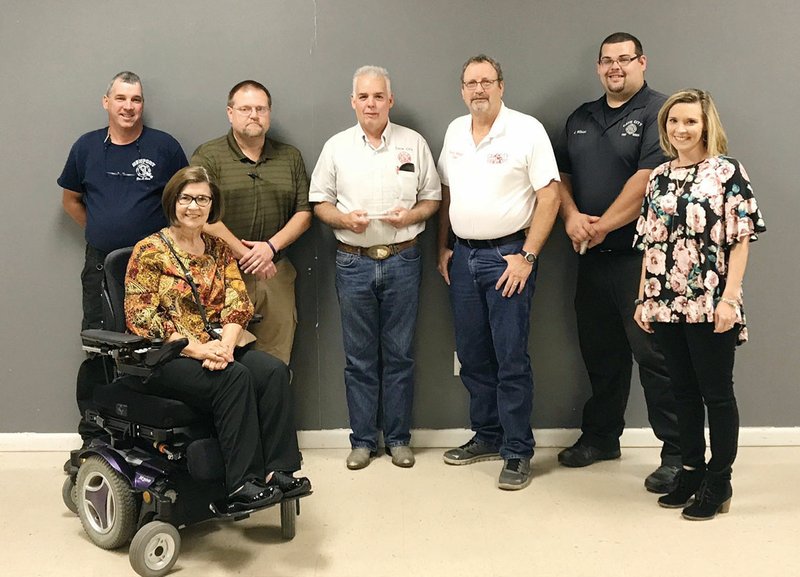 Longtime Cave City firefighter Kenneth “Kenny” Wilson received the Joe Coker Achievement Award from the Three Rivers Firefighters Association during a banquet in Walnut Ridge. Pictured are, seated, Barbara Coker, widow of Joe Coker; and back row, Cave City Fire Department Capt. Curt Coles, Lt. Billy Penn, Kenny Wilson, Chief Ronny Milligan, driver Justin Wilson and Jessica Coker Light, daughter of Joe and Barbara Coker.