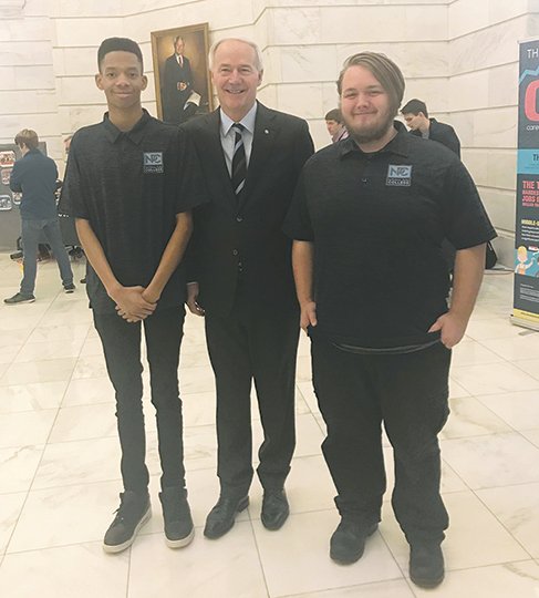 Submitted photo From left, National Park Technology Center students Rayshaun McNary and Caleb Holstine meet Gov. Asa Hutchinson during a recent visit to the Arkansas state Capitol. The graphic design students made a presentation during the inaugural Career and Technical Education Showcase.