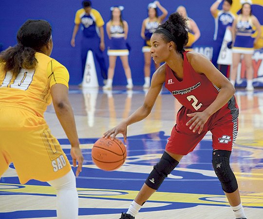 Submitted photo GOLDEN PINK: Sophomore guard Pink Jones (2) sets up the Henderson State offense Thursday against Ramiah Henry (10) and the Lady Mulerider defense in the Reddies' 83-70 road win in Magnolia. Jones tied for the game-high with 27 points.