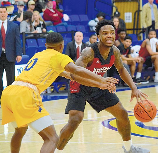 Submitted photo TAPPIN OUT: Henderson State senior guard Kaylon Tappin, back, runs the Reddies' offense Thursday against Draylan Perkins and the Southern Arkansas Muleriders in Magnolia. After the 79-68 loss eliminated Henderson from qualifying for the GAC Tournament, Tappin will play his final game for the Reddies today at 7:30 p.m. against Harding in Searcy.
