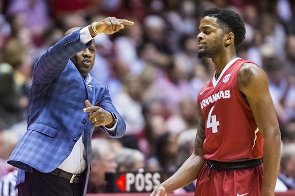 Arkansas coach Mike Anderson works with guard Daryl Macon (4) during the first half of the team's NCAA college basketball game against Alabama on Saturday, Feb. 24, 2018, in Tuscaloosa, Ala. (Vasha Hunt/AL.com via AP)