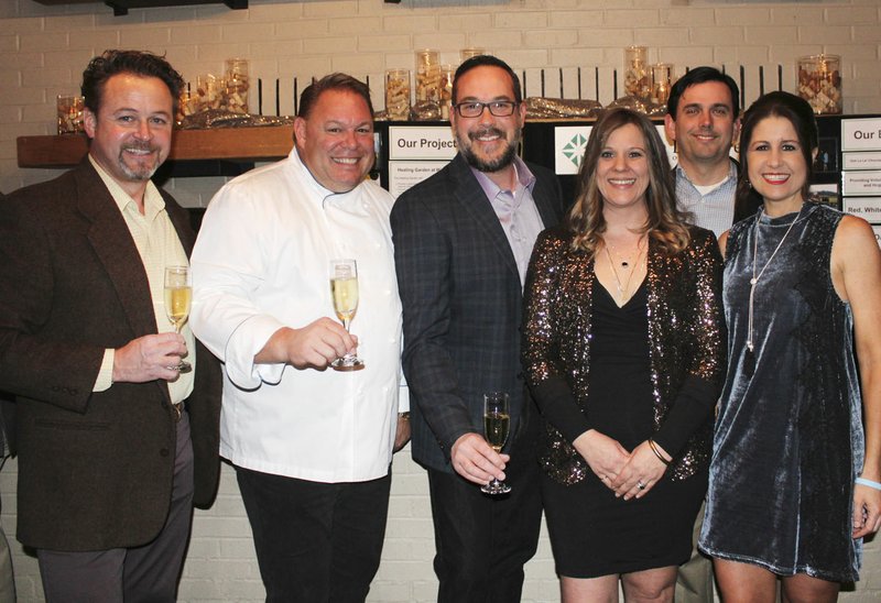 NWA Democrat-Gazette/CARIN SCHOPPMEYER Dan Comstock (from left), Chef Miles James, Jason Willems, Audre Darling and James and Angie Graves welcome guests to Ooh! La,la! on Feb. 8 at The Garden Room in Fayetteville.
