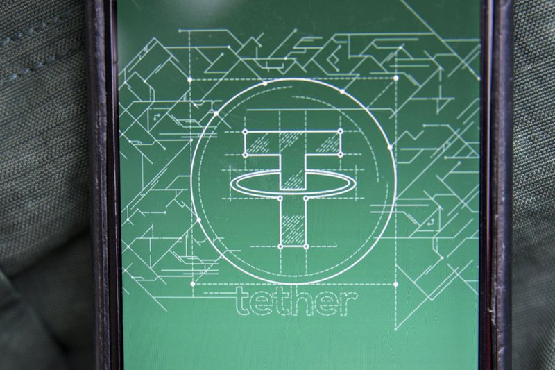 The Tether logo is seen on a smartphone in an arranged photograph taken in Washington, D.C., on Dec. 5, 2017. (MUST CREDIT: Andrew Harrer/Bloomberg)