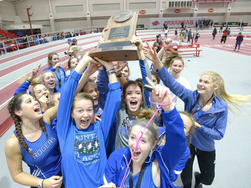 NWA Democrat-Gazette/ANDY SHUPE Members of the Rogers High girls track and field team celebrate their state championship Saturday at the Randal Tyson Track Center in Fayetteville. Visit nwadg.com/photos for more photos from the meet.