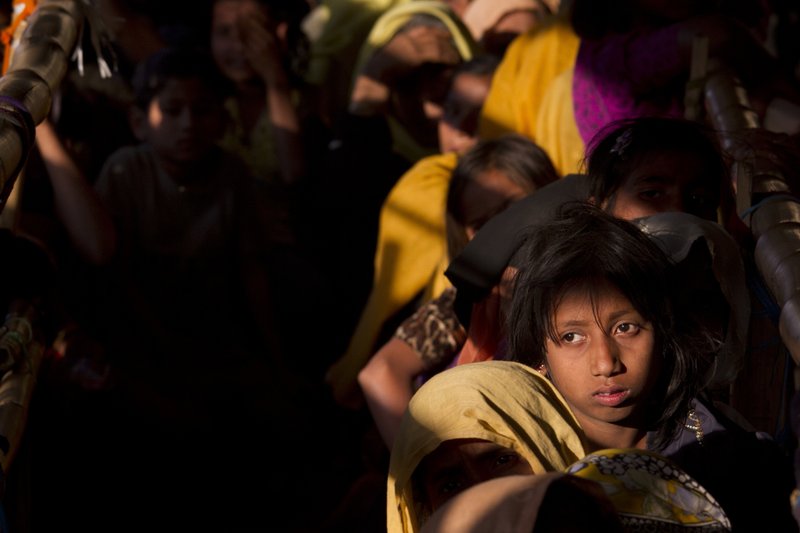 In this Saturday, Jan. 27, 2018, file photo, Rohingya Muslim women refugees wait in a queue to receive relief material at the Balukhali refugee camp near Cox's Bazar, Bangladesh, Saturday, Jan. 27, 2018. Three female Nobel Peace Laureates are beginning a weeklong trip to Bangladesh to meet Rohingya women who have been tortured, raped and even killed by Myanmar soldiers amid a delayed repatriation process. (AP Photo/Manish Swarup, File)