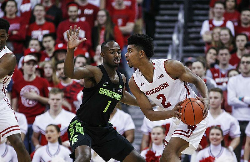 Michigan State’s Joshua Langford (1) scores two of his five points in the Spartans’ 68-63 victory over Wisconsin on Sunday in Madison, Wis. The victory allowed the Spartans to win the Big Ten outright.