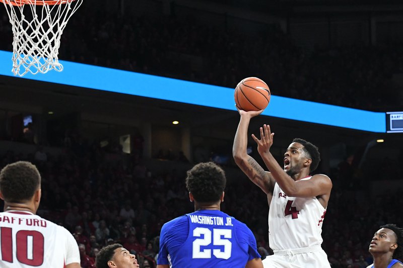 Arkansas' Daryl Macon takes the ball to the basket against Kentucky Tuesday Feb. 20, 2018 during the second half at Bud Walton Arena in Fayetteville.