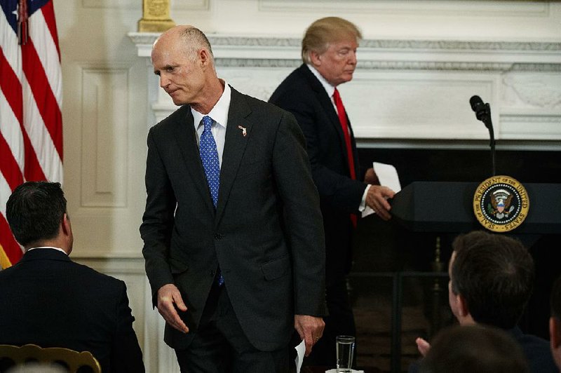 Gov. Rick Scott of Florida walks off after speaking about school safety during a meeting with President Donald Trump and members of the National Governors Association in the State Dining Room of the White House on Monday in Washington.