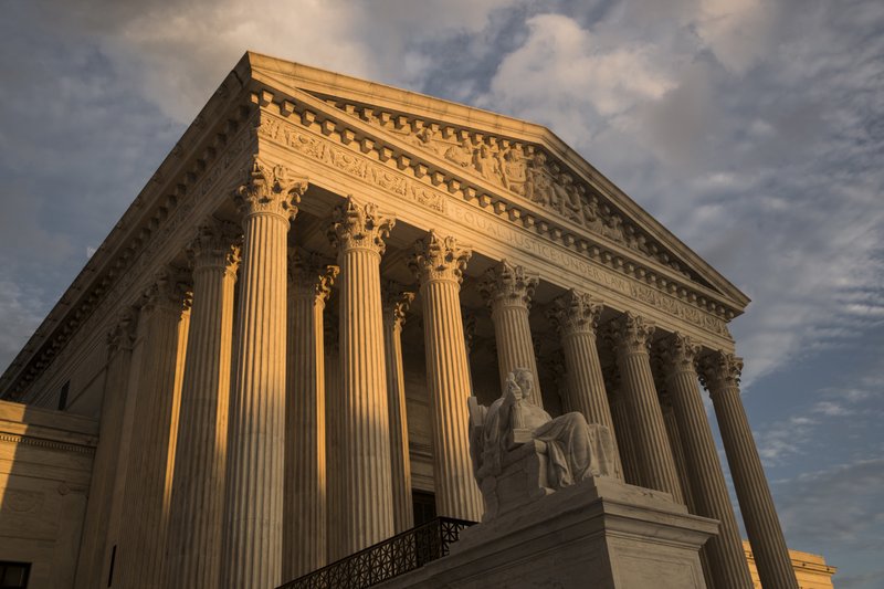 FILE - In this Oct. 10, 2017, file photo, the Supreme Court in Washington, at sunset. The Supreme Court is hearing arguments in a case that could deal a painful financial blow to organized labor. All eyes will be on Justice Neil Gorsuch on Monday, Feb. 26, 2018, when the court takes up a challenge to an Illinois law that allows unions representing government employees to collect fees from workers who choose not to join. The unions say the outcome could affect more than 5 million government workers in 24 states and the District of Columbia. (AP Photo/J. Scott Applewhite, File)