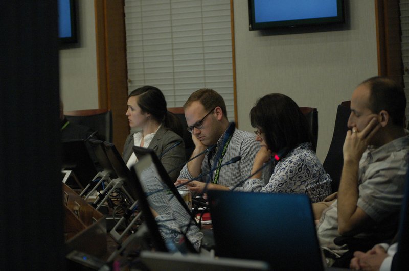 NWA Democrat-Gazette/STACY RYBURN From left, Alli Quinlan, Matt Johnson, Leslie Belden and Zara Niederman, all Fayetteville planning commissioners, look over plans during a commission meeting at City Hall on Monday.