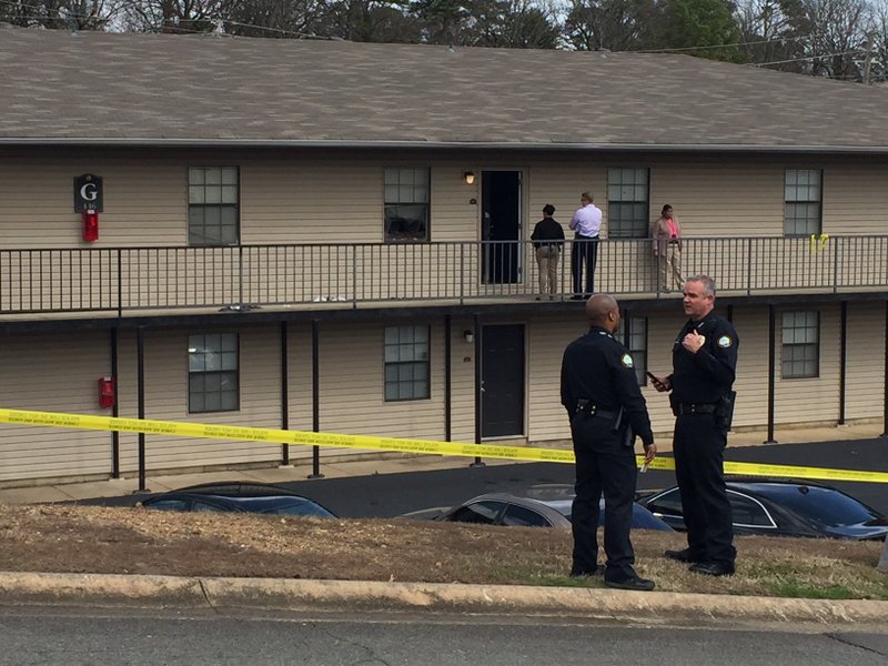 Members of the Little Rock police talk at Bowman Heights Apartments, the scene of an officer-involved shooting Tuesday, Feb. 27, 2018.