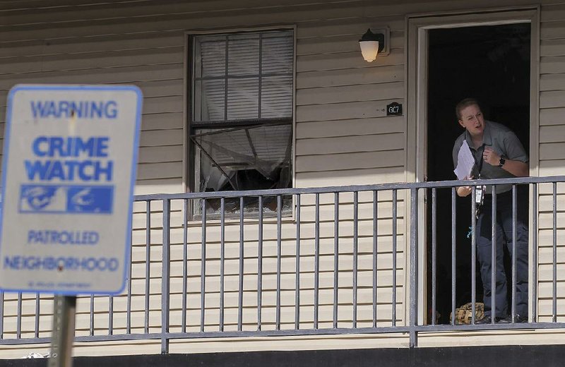 Little Rock police crime scene personnel and detectives investigate a scene at Bowman Heights Apartment at 420 Markham Mesa Place where a police officer shot a man who was trying to break into the officer’s apartment Tuesday morning. The man was taken to the hospital in serious condition.