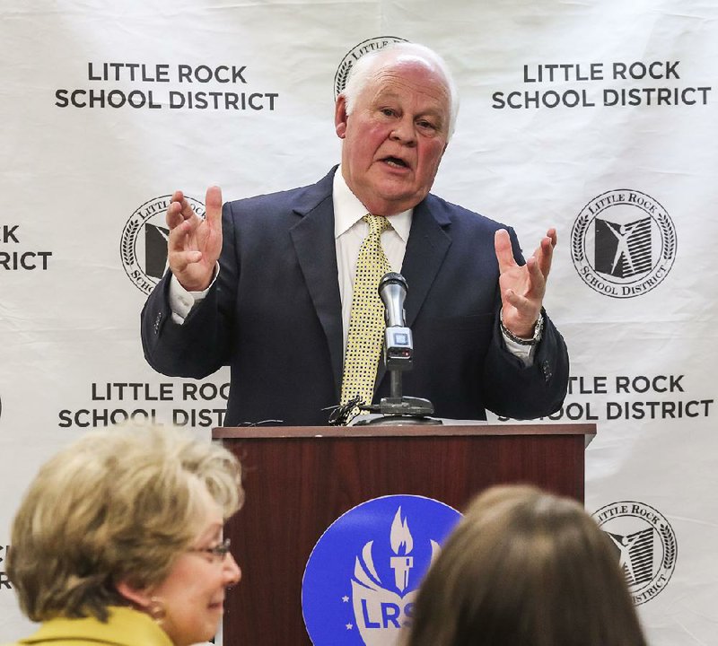 Little Rock Central football coach Ellis “Scooter” Register announced his retirement Tuesday in a news conference at the Little Rock School District administration building. At bottom left is Central High Principal Nancy Rousseau.