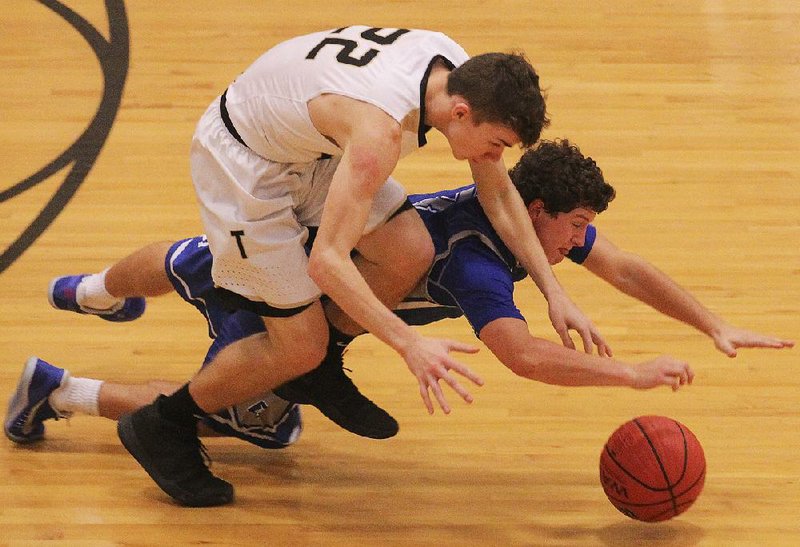 Payton Hayes (left) of Hot Springs and Greenbrier’s Steven Stewart dive for a loose ball during Tuesday’s first-round game at the Class 5A boys state tournament at Maumelle High School.