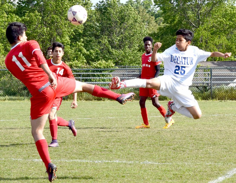 Westside Eagle Observer/MIKE ECKELS Kelvin Moreno (Decatur 25) goes toe to toe with a Tiger player during the May 5, 2017, Decatur-Dardanelle soccer match at Bulldog Stadium in Decatur. The Bulldogs begin their 2018 season March 6 at home against the Life Way Warriors from Centerton.